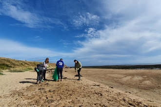 Young people doing beach litter pick