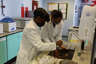 Two people conducting lab work with river samples
