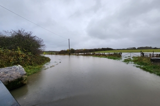 Mallard Way (Road) flooded and flooding over the adjacent fields