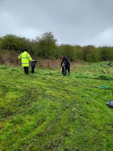 Volunteers clearing litter on field