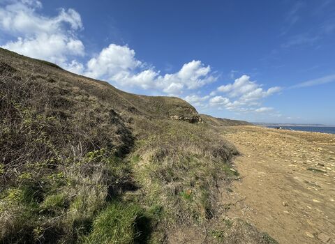 coastal cliffs and beach with blue sky